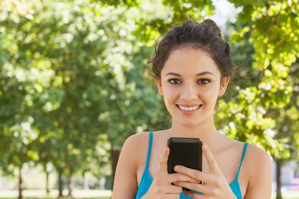 Portrait of young woman texting with her smartphone