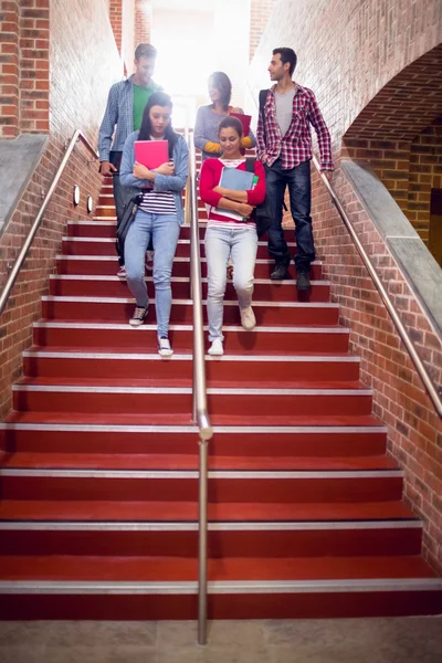 College students walking down stairs in college