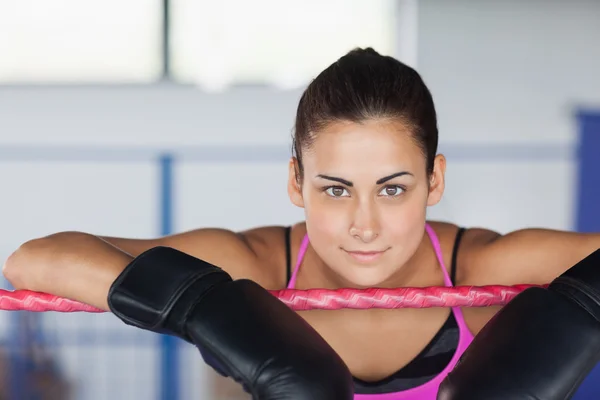 Beautiful young woman in black boxing gloves