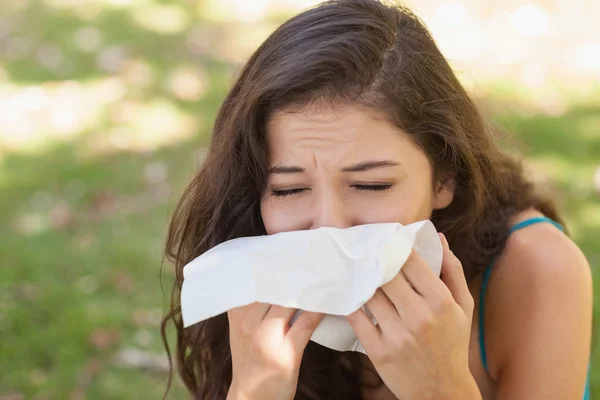 Sick young woman using a handkerchief