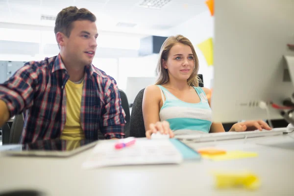 Happy students working together in the computer room