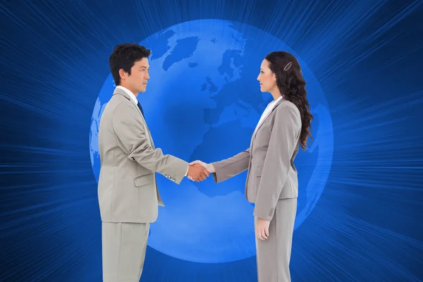 Side view of hand shaking trading partners