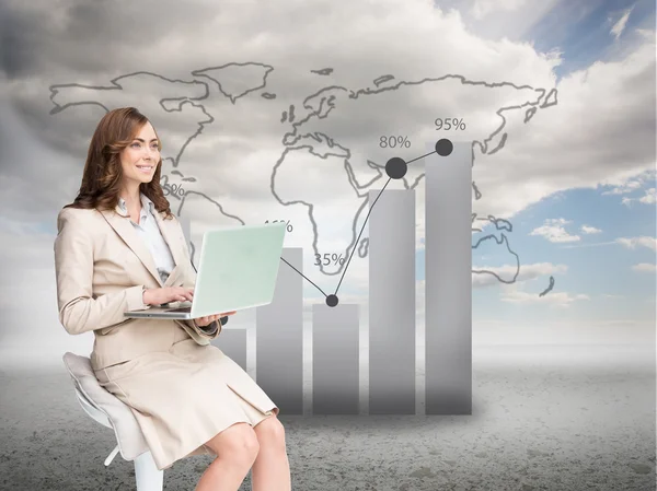 Businesswoman sitting and using laptop