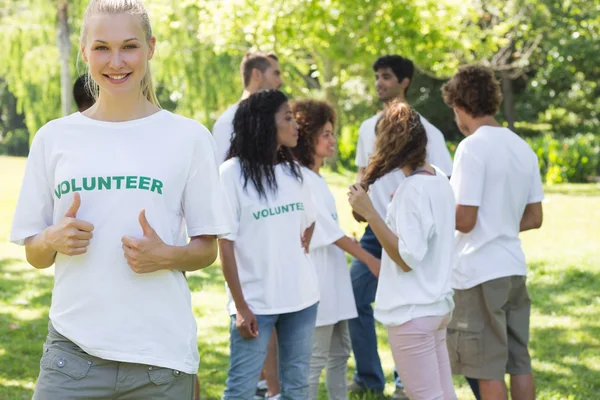 Beautiful volunteer gesturing thumbs up