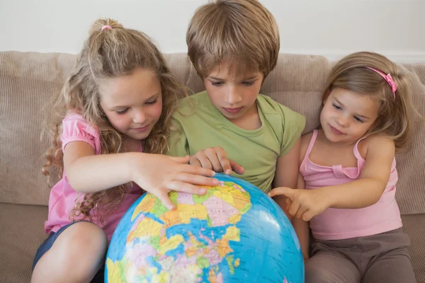 Three kids with globe