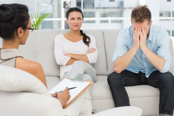 Couple sitting on sofa at therapy session