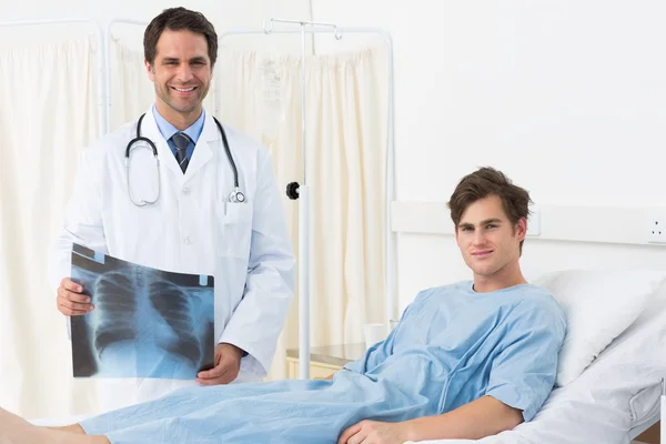 Doctor with Xray report and patient