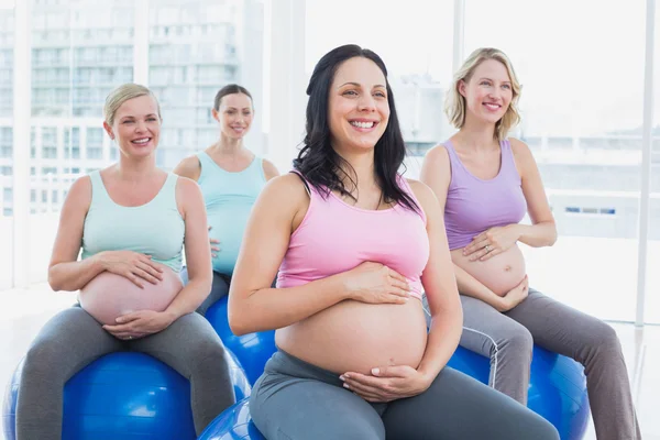 Pregnant women sitting on exercise balls