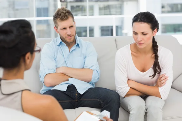Couple with arms crossed at therapy session