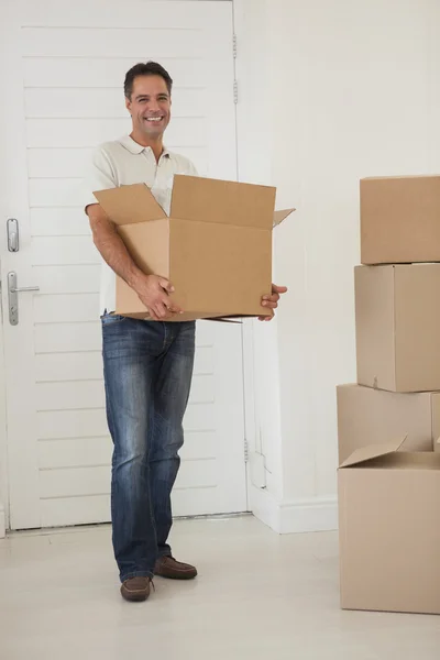 Man carrying boxes in new house