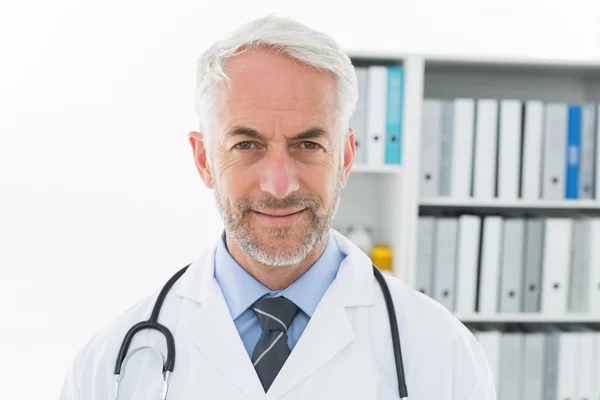 Smiling confident male doctor at medical office