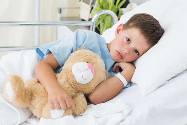 Boy with teddy bear in hospital
