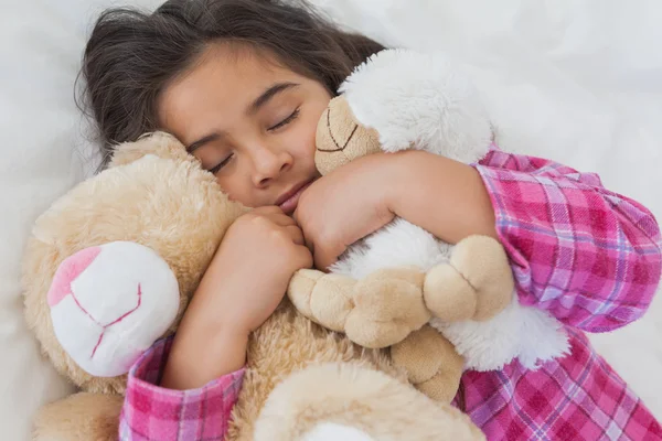 Girl sleeping with stuffed toys