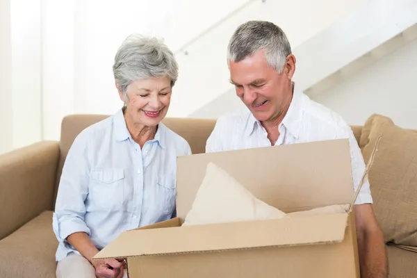 Smiling senior couple moving into new home