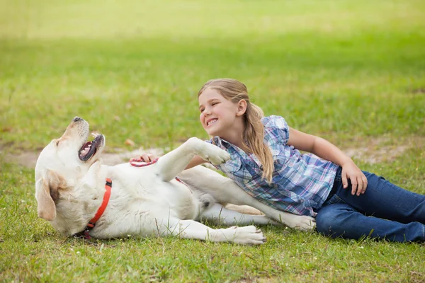 Girl playing with pet dog