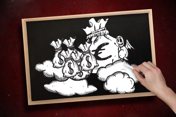 Hand drawing money bags with chalk