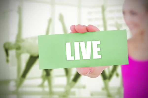 Fit blonde holding card saying live
