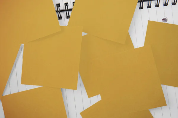 Yellow paper strewn over notepad