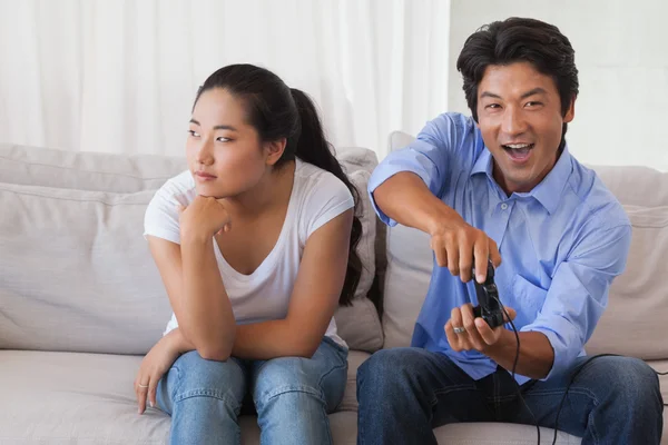 Man ignoring his girlfriend playing video games