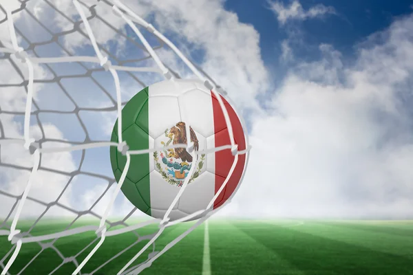 Composite image of football in mexico colours at back of net