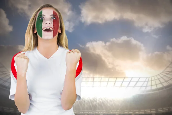 Composite image of excited italy fan in face paint cheering