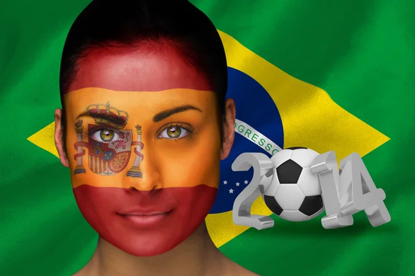 Composite image of spanish football fan in face paint