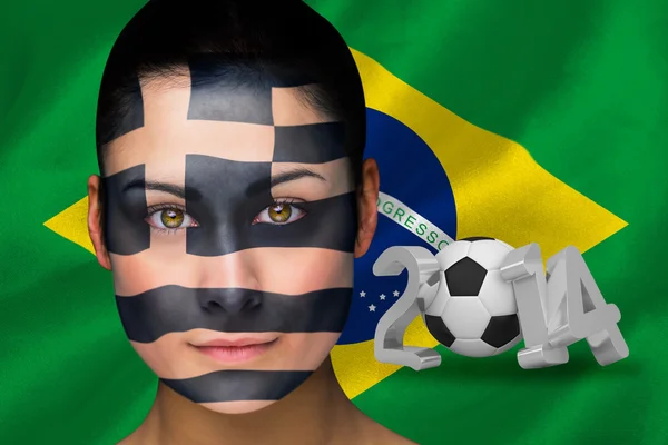 Composite image of greek football fan in face paint