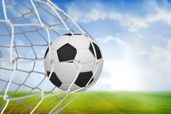 Composite image of football at back of net