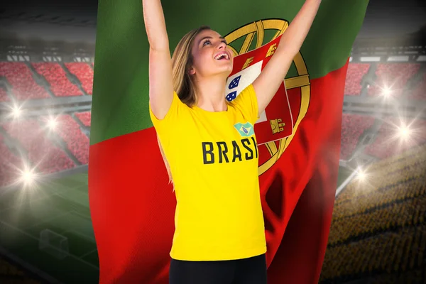 Excited football fan in brasil tshirt holding flag
