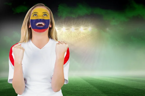 Composite image of excited colombia fan in face paint cheering