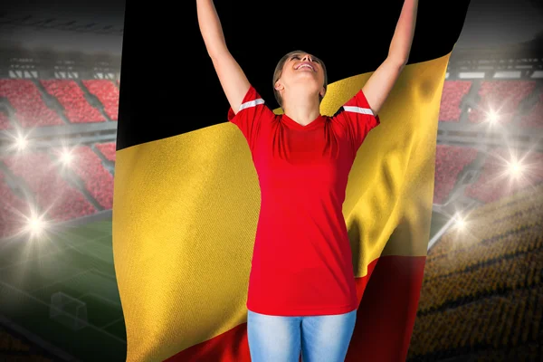 Composite image of cheering football fan in red holding belgium