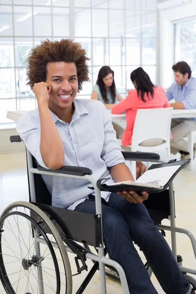 Businessman in wheelchair holding planner