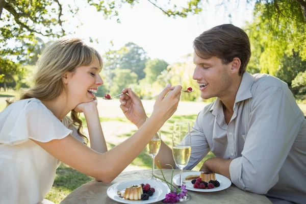 Couple feeding each other dessert