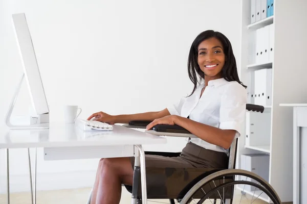 Businesswoman in wheelchair working