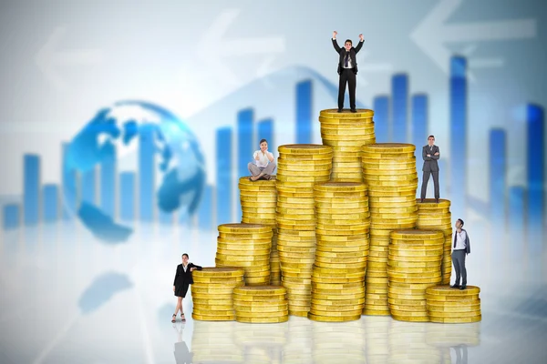 Business people on pile of coins