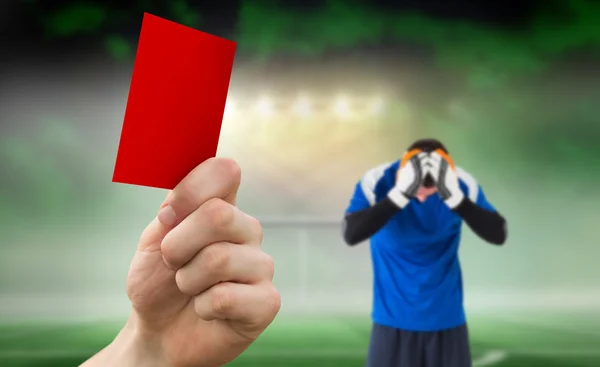 Hand holding up red card