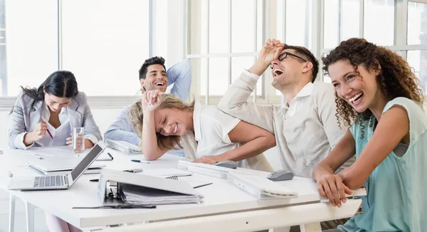 Business team laughing during meeting