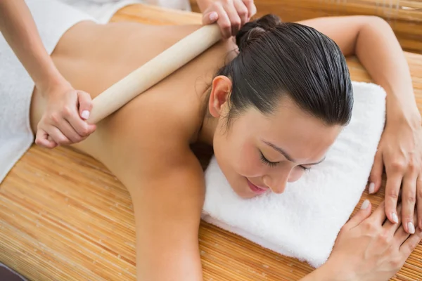 Brunette getting a bamboo massage