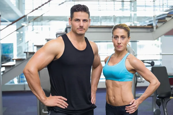 Bodybuilding man and woman frowning