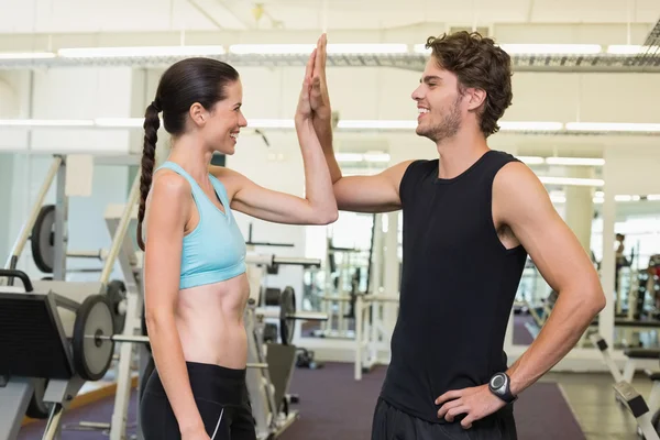 Fit man and woman high fiving
