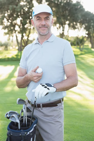 Handsome golfer with golf bag