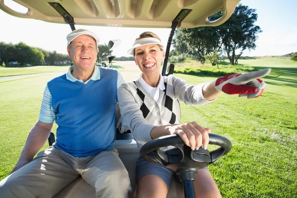 Golfing couple sitting in golf buggy