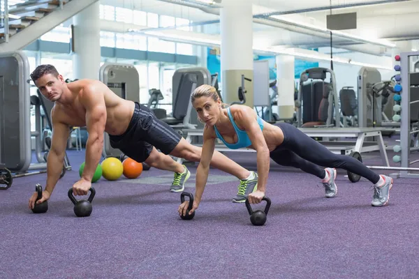Bodybuilding man and woman in plank position