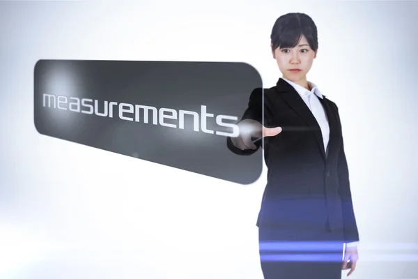 Businesswoman pointing to word measurements