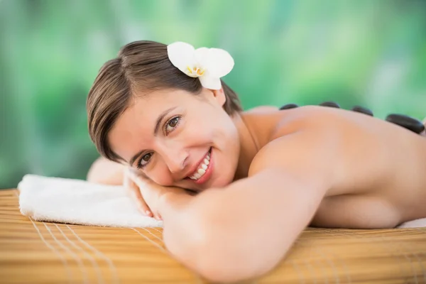 Beautiful woman receiving stone massage at health farm