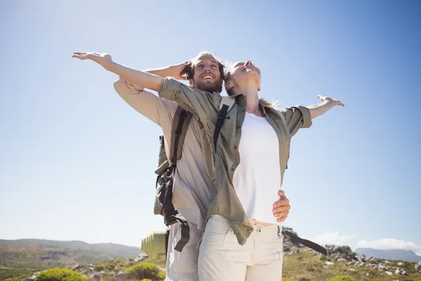 Couple on mountain terrain admiring view