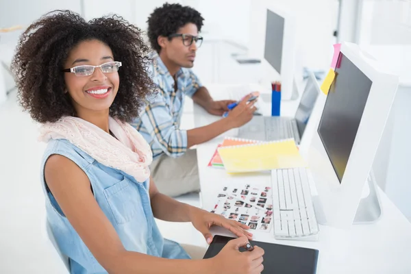 Happy design team working at desk