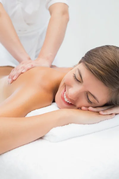 Attractive woman receiving back massage at spa center