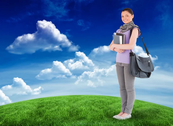 Student holding books and bag