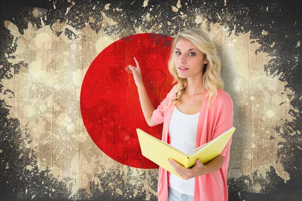 Student pointing against japan flag